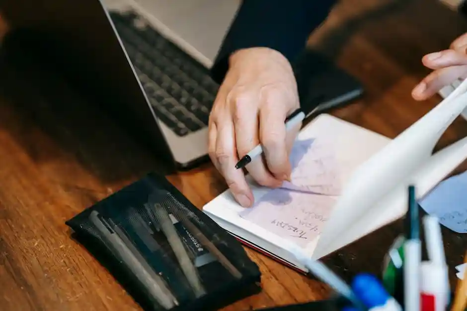 person planning side hustle with notebook and laptop - how to make money on the side person planning side hustle with notebook and laptop - how to make money on the side